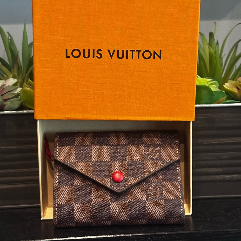 Louis Vuitton Checkered Wallet with red interior.